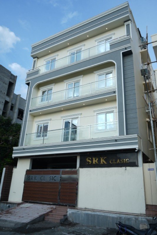 Three-storey elevation with glass balconies