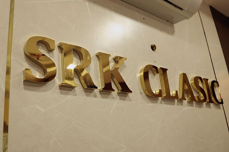 The brass SRK Clasic sign above the entrance on 3rd Main Road
