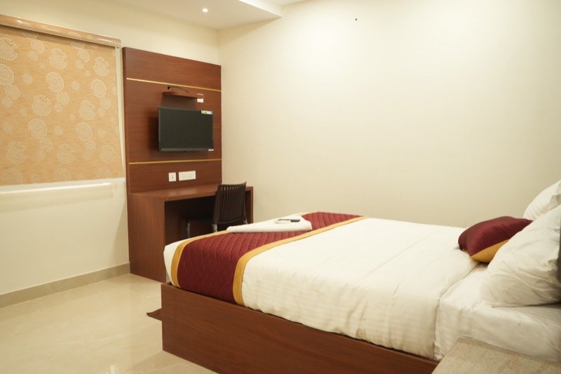 Premium King Suite at SRK Clasic with a king bed, work desk and wall-mounted television