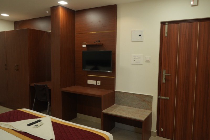 Television panel, desk and luggage bench in a Premium room