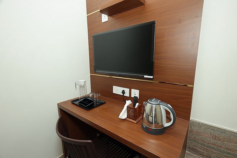 Writing desk with kettle and tea tray in a guest room at SRK Clasic